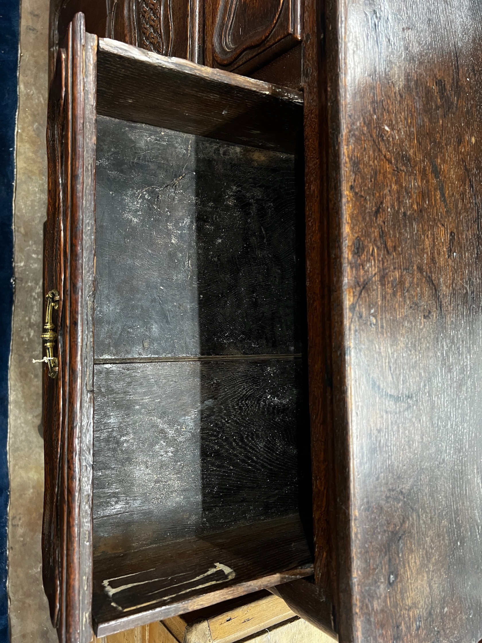 An 18th century French Provincial oak buffet, lacking two feet, width 171cm depth 48cm height 110cm